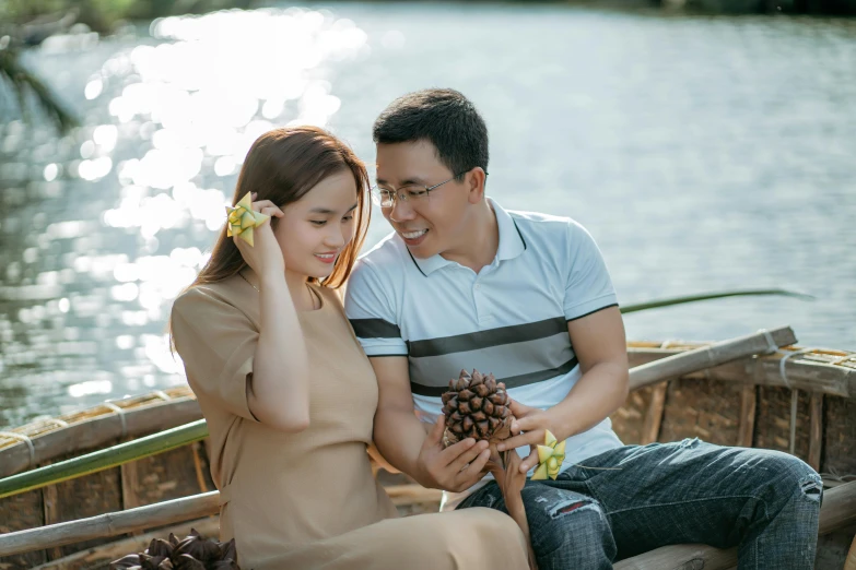 a man and woman sitting next to each other on a boat, pexels contest winner, phuoc quan, at a park, yummy, crisp detail