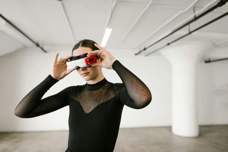 a woman in a black leo leo leo leo leo leo leo leo leo leo leo leo leo leo leo leo leo leo leo leo, a hologram, by Nina Hamnett, trending on unsplash, video art, : kanye west wearing vr goggles, modern dance aesthetic, holds a smart phone in one hand, fzd school of design