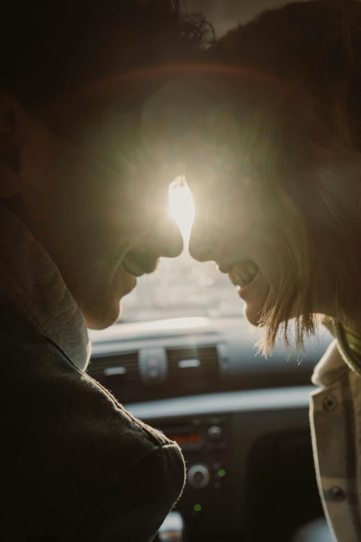 a man and woman in a car looking into each other's eyes, a picture, pexels contest winner, romanticism, subtle lens flare, back lit, instagram post, light haze