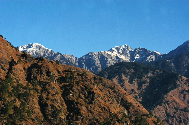 a group of people standing on top of a mountain, uttarakhand, profile image, clear blue skies, thumbnail