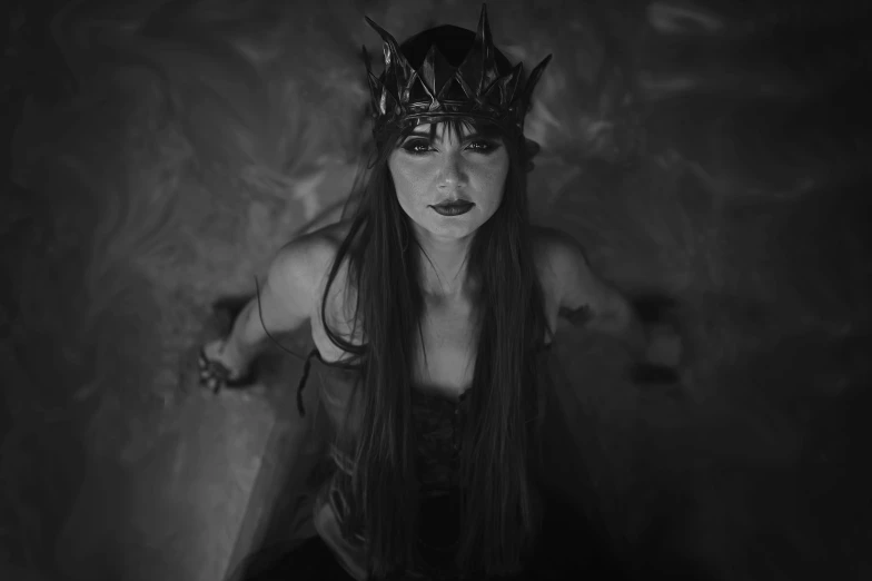 a woman with long hair wearing a crown, a black and white photo, trending on cgsociety, gothic art, 35mm dramatic lighting, iron crown, still from a music video, succubus