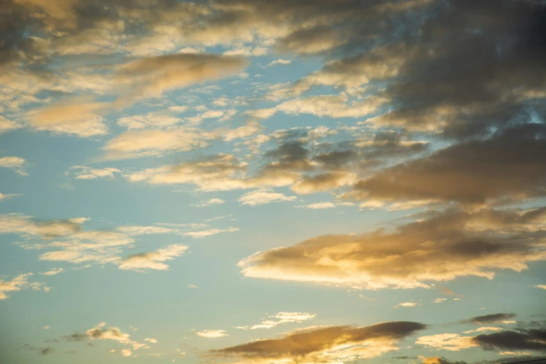 a man flying a kite on top of a lush green field, a picture, inspired by Elsa Bleda, unsplash, sunset clouds, cumulus clouds, pale beige sky, today\'s featured photograph 4k