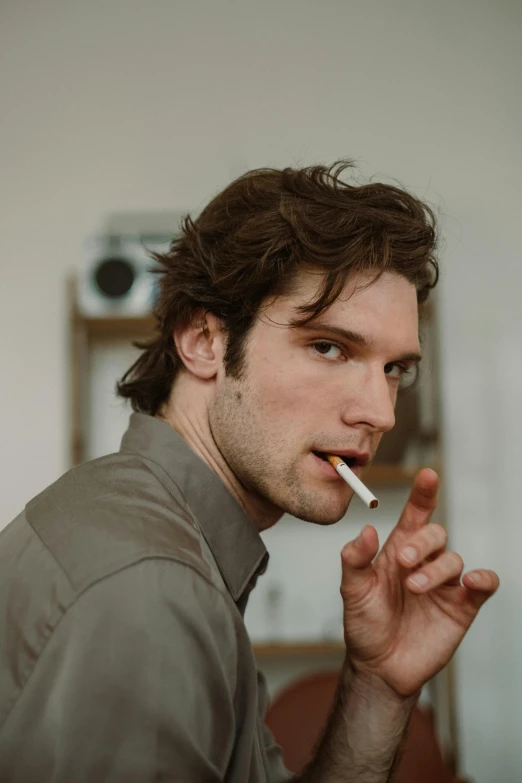 a man with a cigarette in his mouth, an album cover, by Adam Dario Keel, unsplash, renaissance, orelsan, meet the actor behind the scenes, pewdiepie, with pale skin