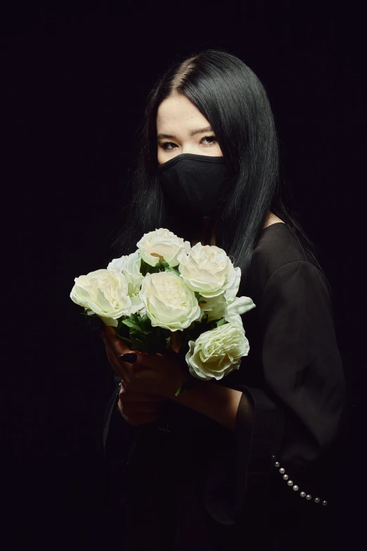 a woman wearing a black mask holding a bouquet of white roses, an album cover, inspired by Zhu Da, unsplash, with long black hair, dark. no text, techwear, 奈良美智