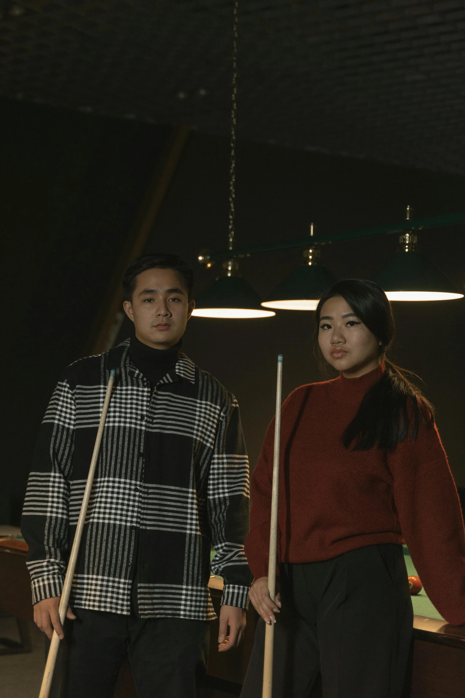 a man and a woman standing next to a pool table, an album cover, by Jang Seung-eop, wearing a turtleneck and jacket, siblings, b - roll, ( ( theatrical ) )