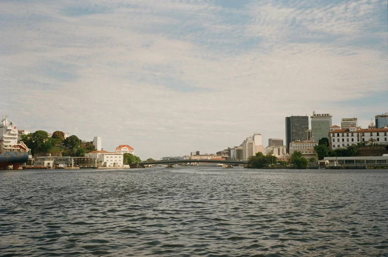 a body of water with buildings in the background, a picture, unsplash, sōsaku hanga, alvar aalto, low quality photo, kreuzberg, wide river and lake