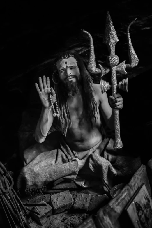 a black and white photo of a man in a cave, inspired by Kailash Chandra Meher, samikshavad, long dreadlocks, as an offering to zeus, triumphant pose, instagram photo