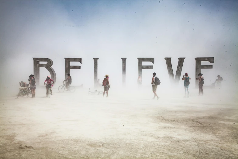a group of people that are standing in the dirt, by Jessie Algie, unsplash contest winner, graffiti, salt flats with scattered ruins, volumetric mist, billboard image, breathe