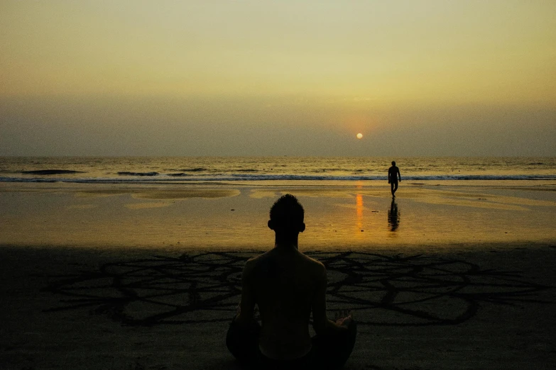 a couple of people sitting on top of a sandy beach, pexels contest winner, minimalism, sacral chakra, silhouette of a man, in the early morning, black sand