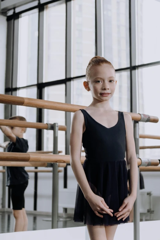 a little girl standing in a dance studio, inspired by Elizabeth Polunin, pexels contest winner, greta thunberg smiling, black, wētā fx, aged 13
