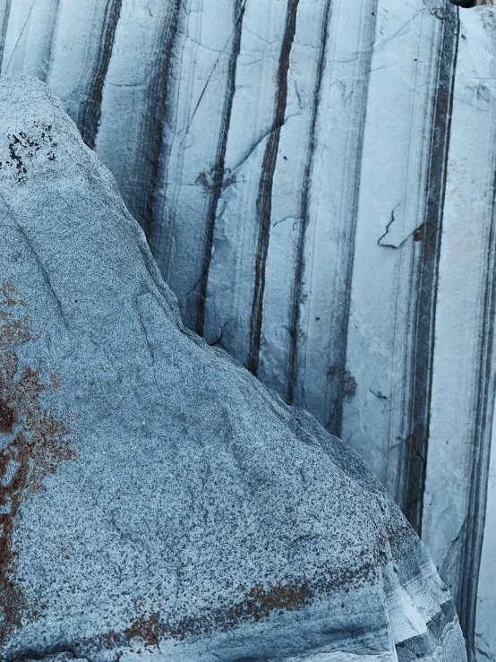 a man flying through the air while riding a snowboard, an album cover, inspired by Per Kirkeby, unsplash, concrete art, high detailed thin stalagtites, ((rocks)), detail shot, striations