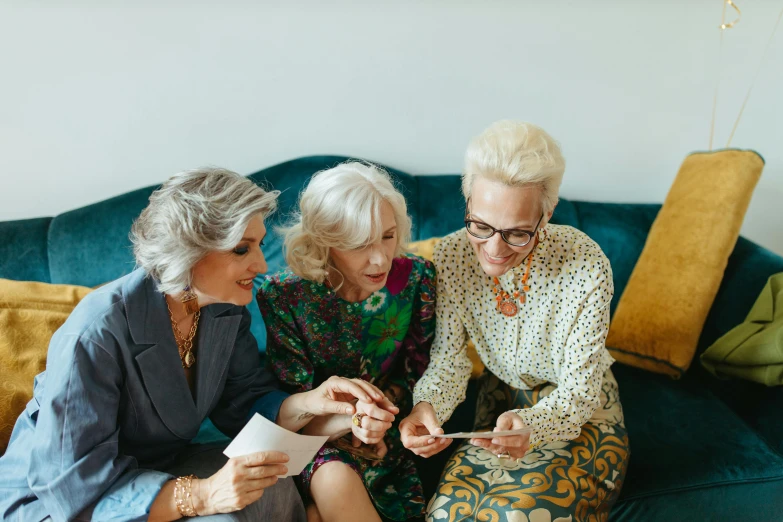 a group of women sitting on top of a blue couch, by Emma Andijewska, pexels contest winner, elderly, precious gems, looking smart, three women