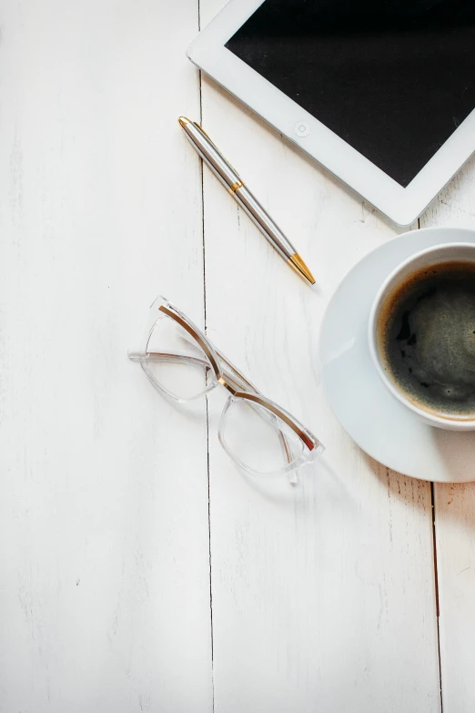 a cup of coffee next to a tablet computer, trending on pexels, minimalism, in square-rimmed glasses, white bg, black chalk, - 9