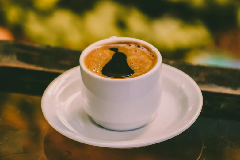 a cup of coffee sitting on top of a saucer, multiple stories, greek, profile image, manuka