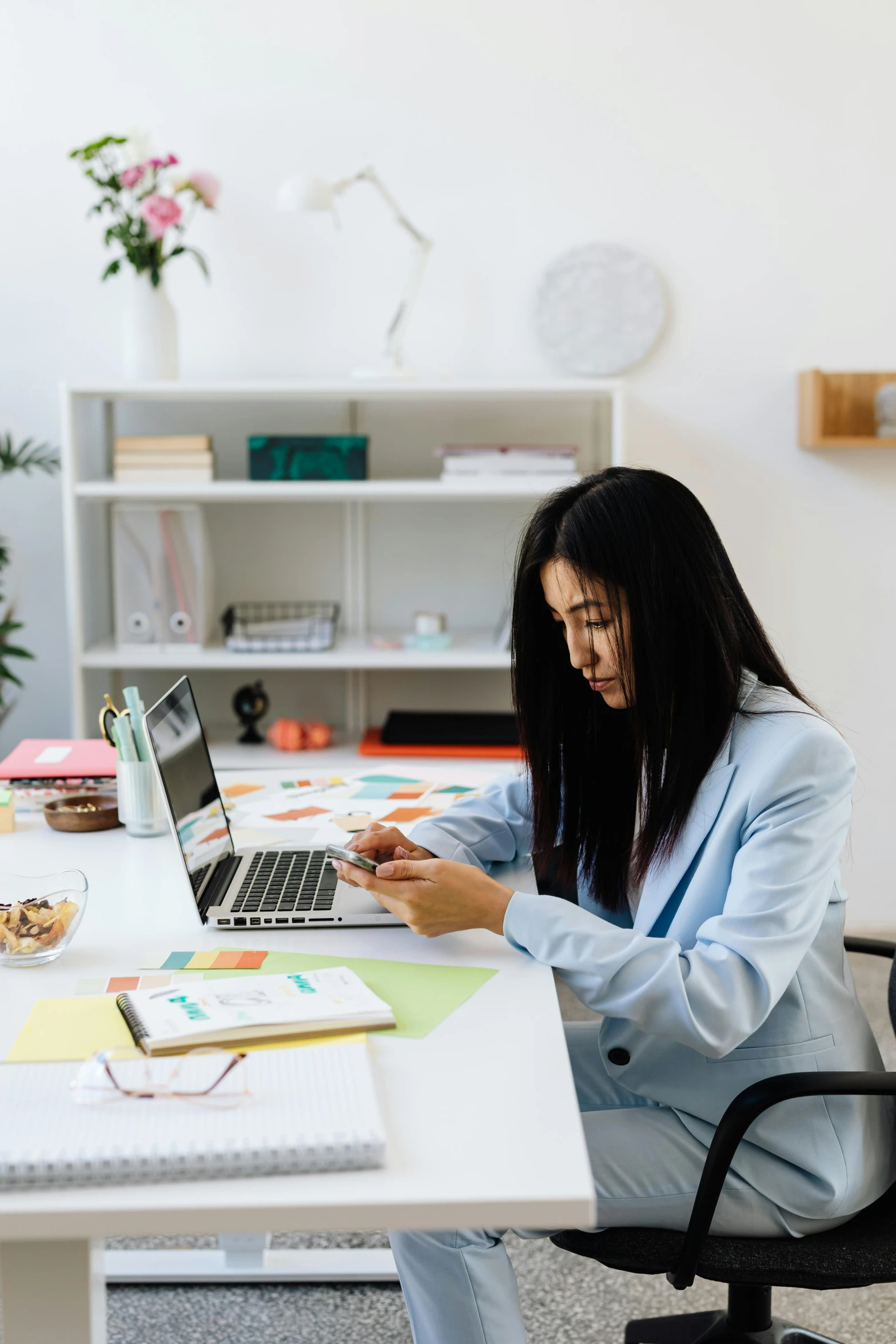 a woman sitting at a desk using a laptop computer, pexels contest winner, checking her phone, asian female, serious business, gif