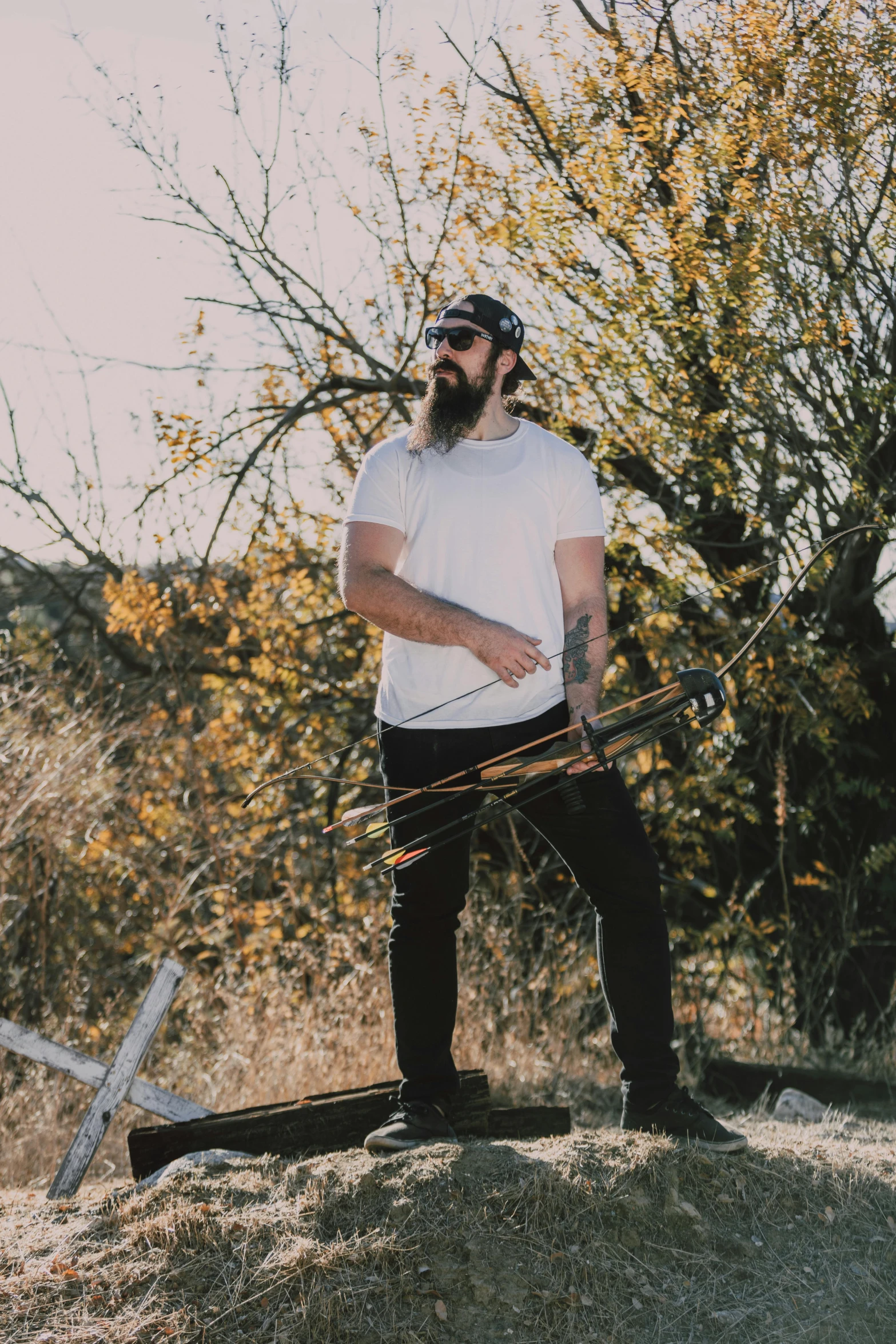 a man standing on top of a hill talking on a cell phone, an album cover, by Matt Cavotta, pexels contest winner, long beard, holding a wooden staff, dustin panzino, instagram picture