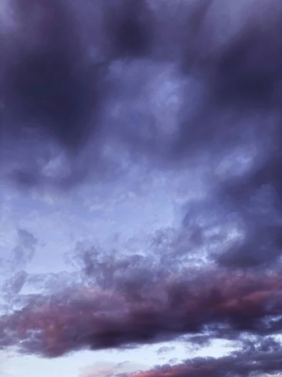 a man flying a kite on top of a lush green field, an album cover, unsplash, romanticism, dark purple clouds, ((purple)), cloudy night, layered stratocumulus clouds