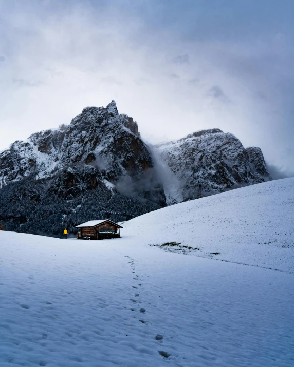 a snow covered mountain with a cabin in the foreground, pexels contest winner, renaissance, dolomites, 2000s photo, multiple stories, album cover