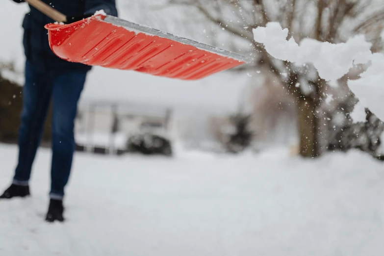 a person holding a snow shovel in the snow, pexels contest winner, carrying a tray, blippi, reflective material, background image