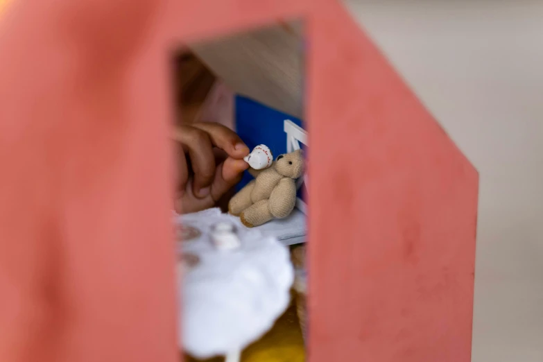 a little girl is playing with a doll house, by Julia Pishtar, pexels contest winner, process art, são paulo, detail shot, coronavirus as a stuffed toy, inside its box