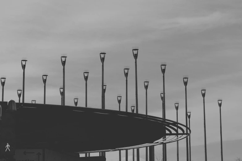 a black and white photo of a bunch of street lights, by Adam Marczyński, pexels contest winner, postminimalism, in future airport rooftop, circular towers, instagram picture, pillars