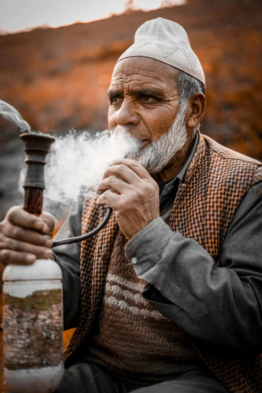 an old man smoking a pipe next to a bottle, inspired by Steve McCurry, pexels contest winner, renaissance, muslim, smokey cannons, profile pic, himalayas