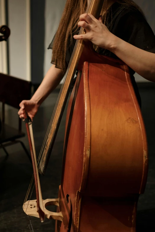 a woman holding a cello in a room, flickr, getty images, 3 jazz musicians, bottom body close up, 15081959 21121991 01012000 4k