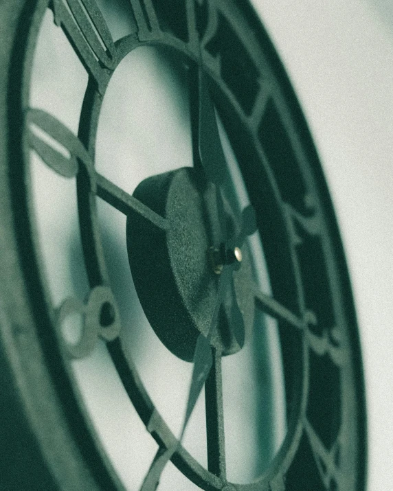 a close up of a clock on a wall, by IAN SPRIGGS, unsplash, arts and crafts movement, 3 d print, muted green, grainy, dishonored aesthetic