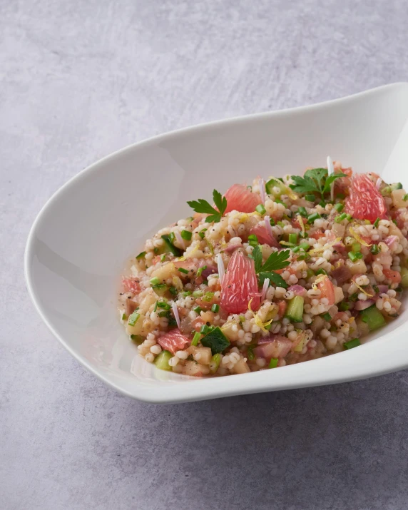 a close up of a bowl of food on a table, pink white and green, heavy grain, citrinitas, relish