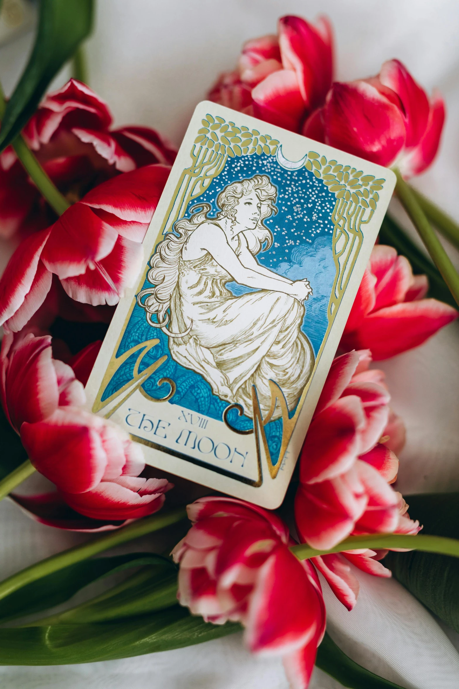 a tarot deck surrounded by red tulips, art nouveau, to the moon, flatlay, mtg card, medium close shot