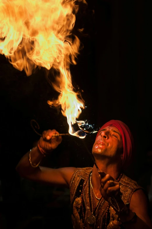 a man that is standing in front of a fire, by Sudip Roy, pexels contest winner, renaissance, fireball lighting her face, circus performance, smoking a magical bong, closeup!!!!!!