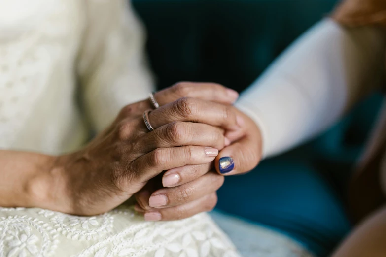 a close up of two people holding hands, unsplash, renaissance, older woman, silver and sapphire, wedding photo, asian women