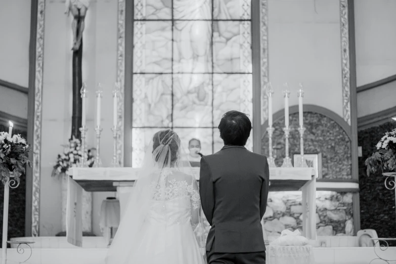 a black and white photo of a bride and groom, unsplash, altar, aoi ogata, catholic, 🤬 🤮 💕 🎀