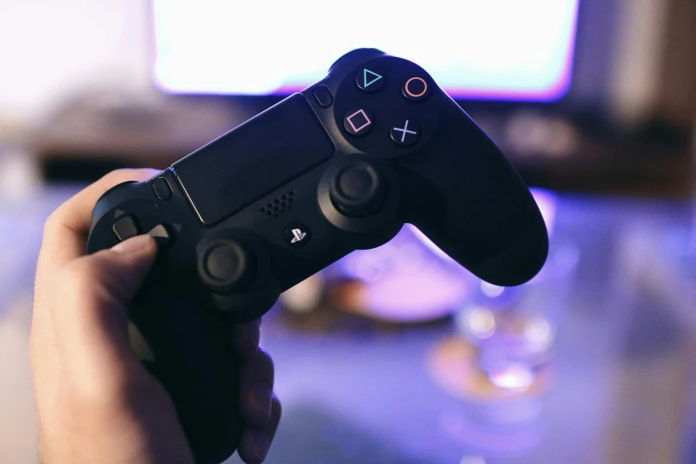 a close up of a person holding a video game controller, by Carey Morris, pexels, ps 4 gameplay, instagram post, purple ambient light, #screenshotsaturday