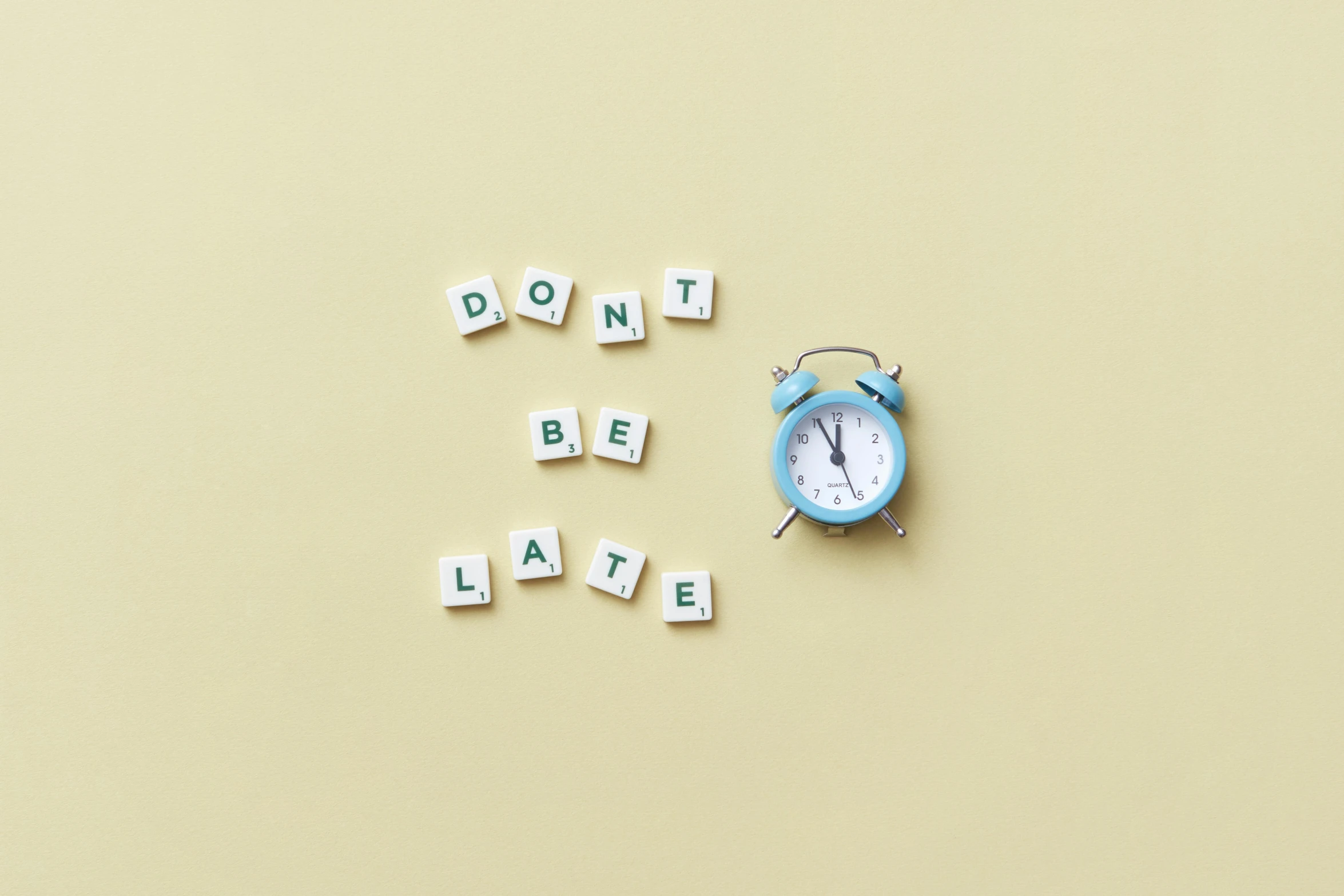 an alarm clock sitting next to the words don't be late, a picture, inspired by Chris LaBrooy, happening, on a pale background, letters, detiled, instagram post