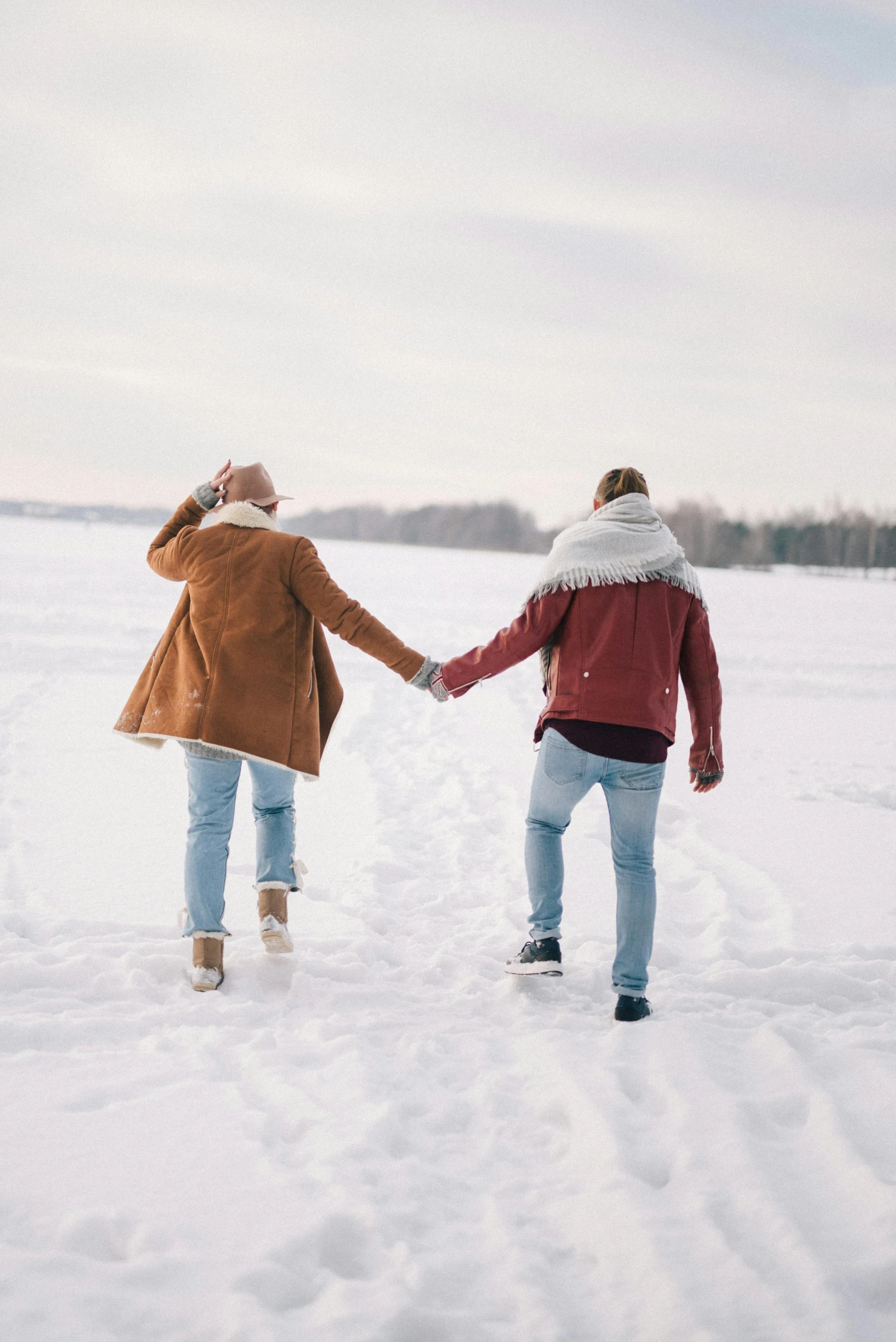 two people walking in the snow holding hands, trending on pexels, romanticism, frozen lake, plain background, cutest, festivals