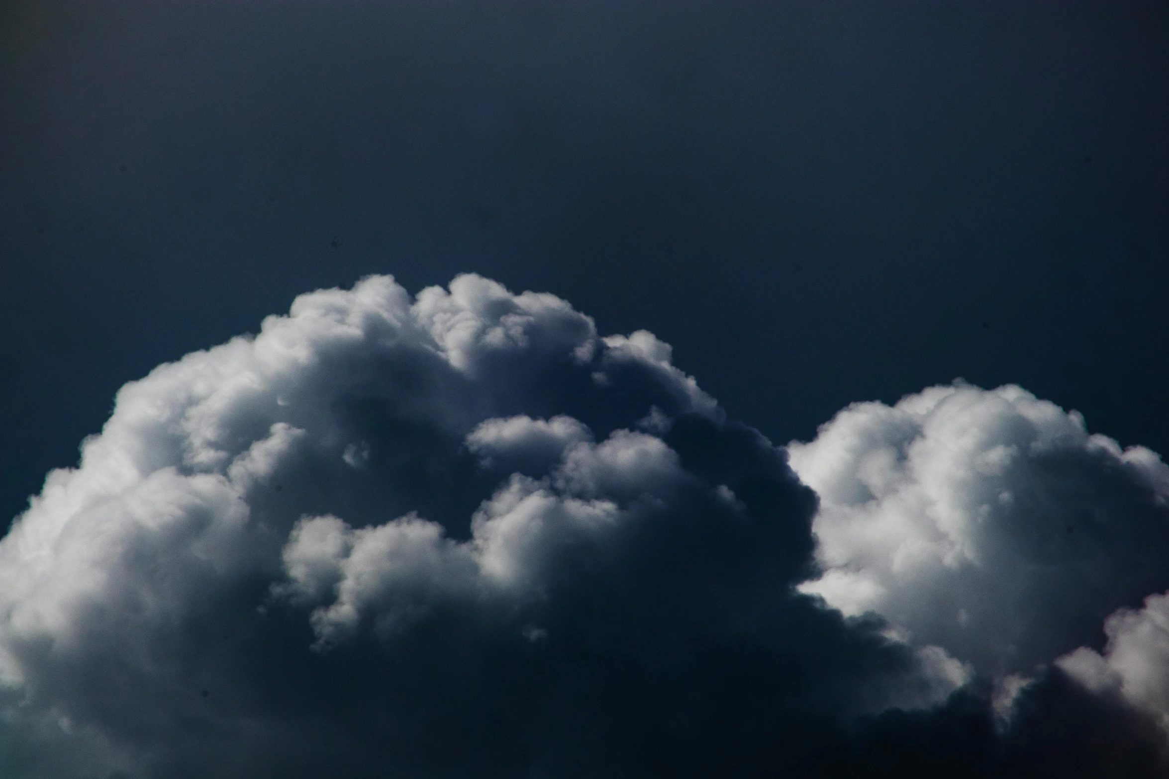 a jetliner flying through a cloudy blue sky, an album cover, inspired by Elsa Bleda, unsplash, romanticism, dark mammatus cloud, black clouds, sitting in a fluffy cloud, fat cloud