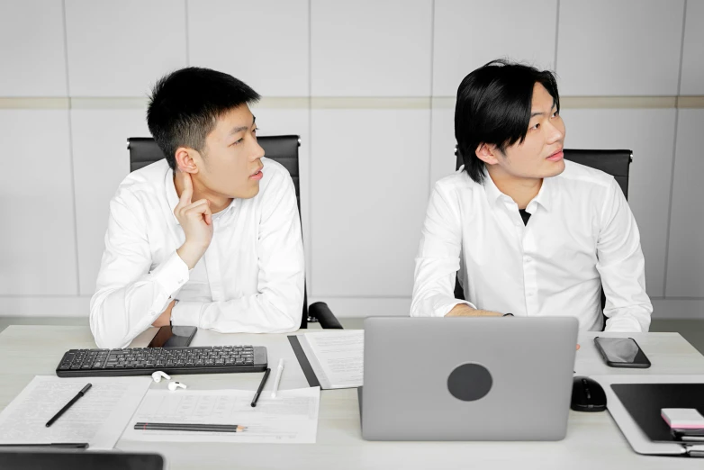 a couple of men sitting at a table with laptops, by Cheng Jiasui, unsplash, avatar image, wearing business casual dress, ethnicity : japanese, stern expression