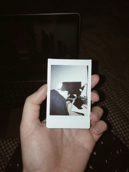 a person holding a polaroid camera in their hand, inspired by Elsa Bleda, serial art, low quality photo, cat photo, ansel ], abstract people in frame