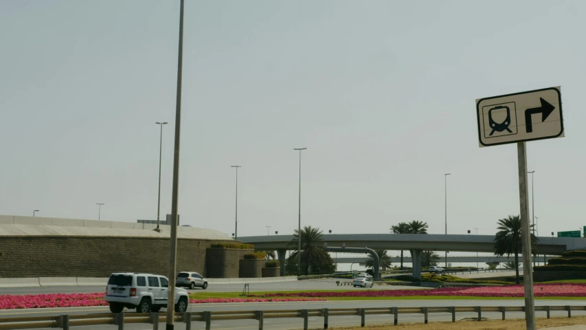 a street sign sitting on the side of a road, a picture, hurufiyya, skybridges, airport, seen from afar, no shade