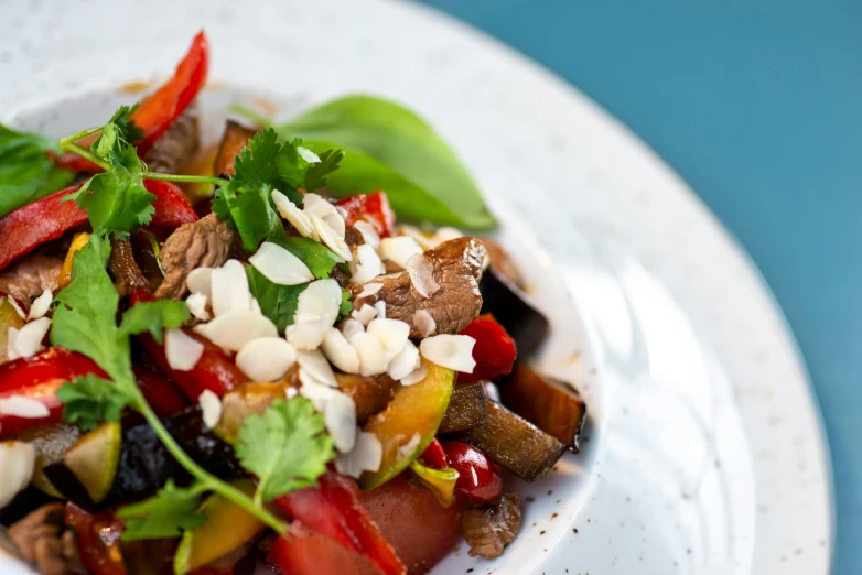 a close up of a plate of food on a table, by Emma Andijewska, lomo saltado, profile image, eggplant, salad