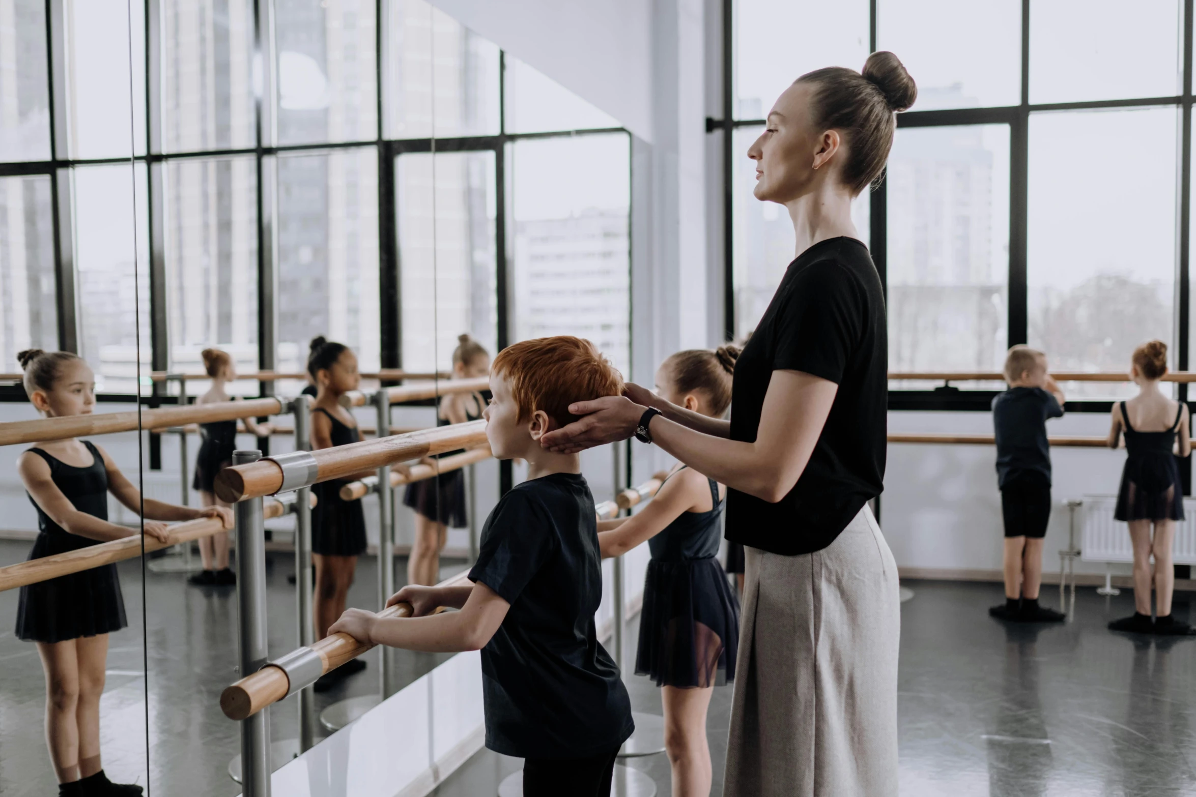 a woman standing next to a little boy in a dance class, by Lee Loughridge, pexels contest winner, arabesque, sydney hanson, thumbnail, high quality photo, flattened