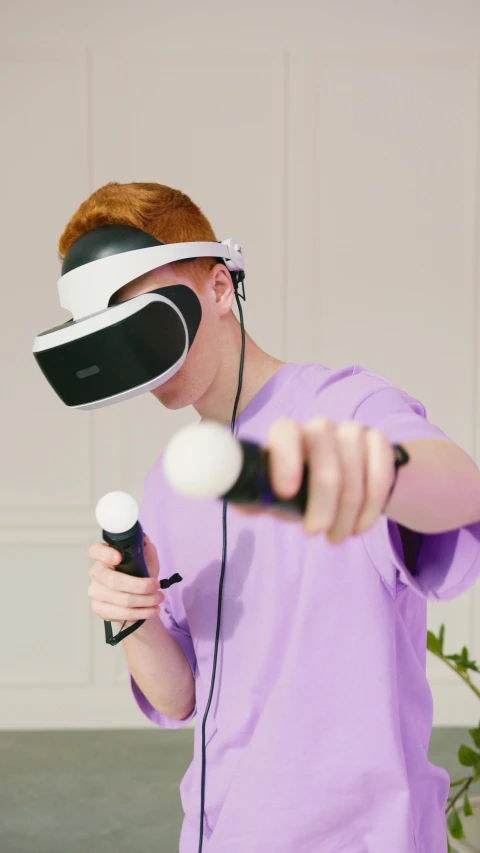 a man in a purple shirt holding a microphone and a video game controller, virtual reality headset, thumbnail, taken with sony alpha 9, dezeen