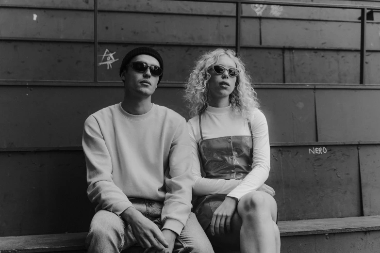 a man and a woman sitting on a bench, a black and white photo, pexels, realism, die antwoord style wear, kim hyun joo, casual pose, sunglasses