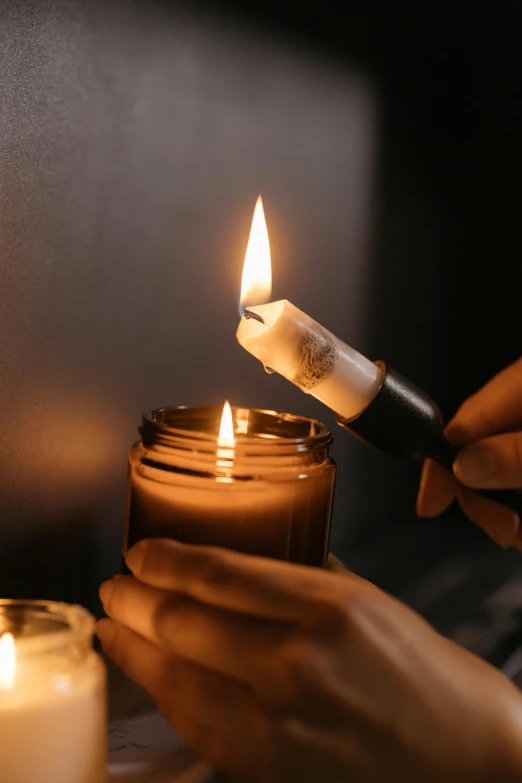 a person lighting a candle on a table, image apothecary, carefully crafted, organic detail, easy to use