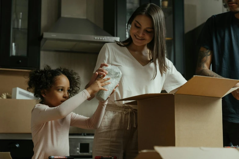 a woman standing next to a little girl in a kitchen, delivering packages for amazon, avatar image, manuka, thumbnail