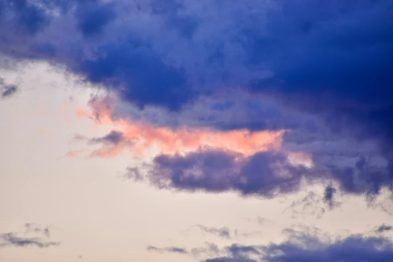 a large jetliner flying through a cloudy sky, an album cover, by Carey Morris, unsplash, romanticism, blue and pink shift, late summer evening, ceremonial clouds, some purple and orange