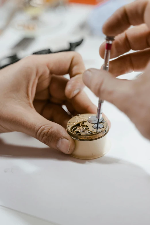 a close up of a person working on a watch, an engraving, mini model, circular, creating a soft, ( mechanical )
