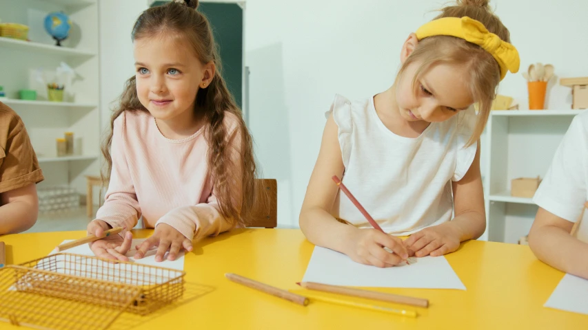 a group of children sitting around a yellow table, a child's drawing, trending on pexels, academic art, two pigtails hairstyle, two girls, girl wearing uniform, lady using yellow dress
