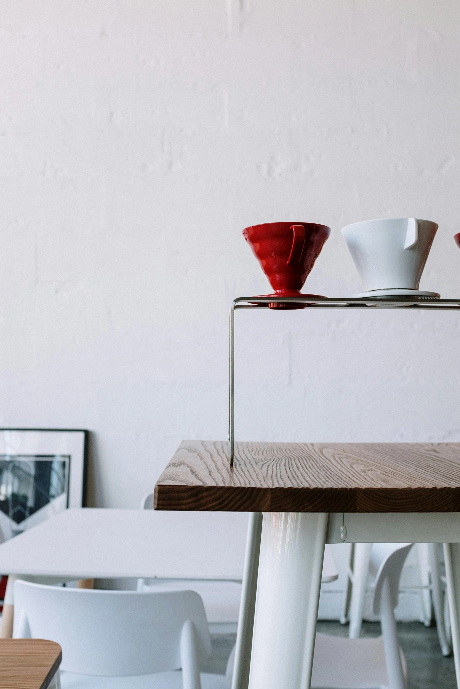 a couple of bowls sitting on top of a wooden table, deus ex machina, crimson themed, shelf, cone